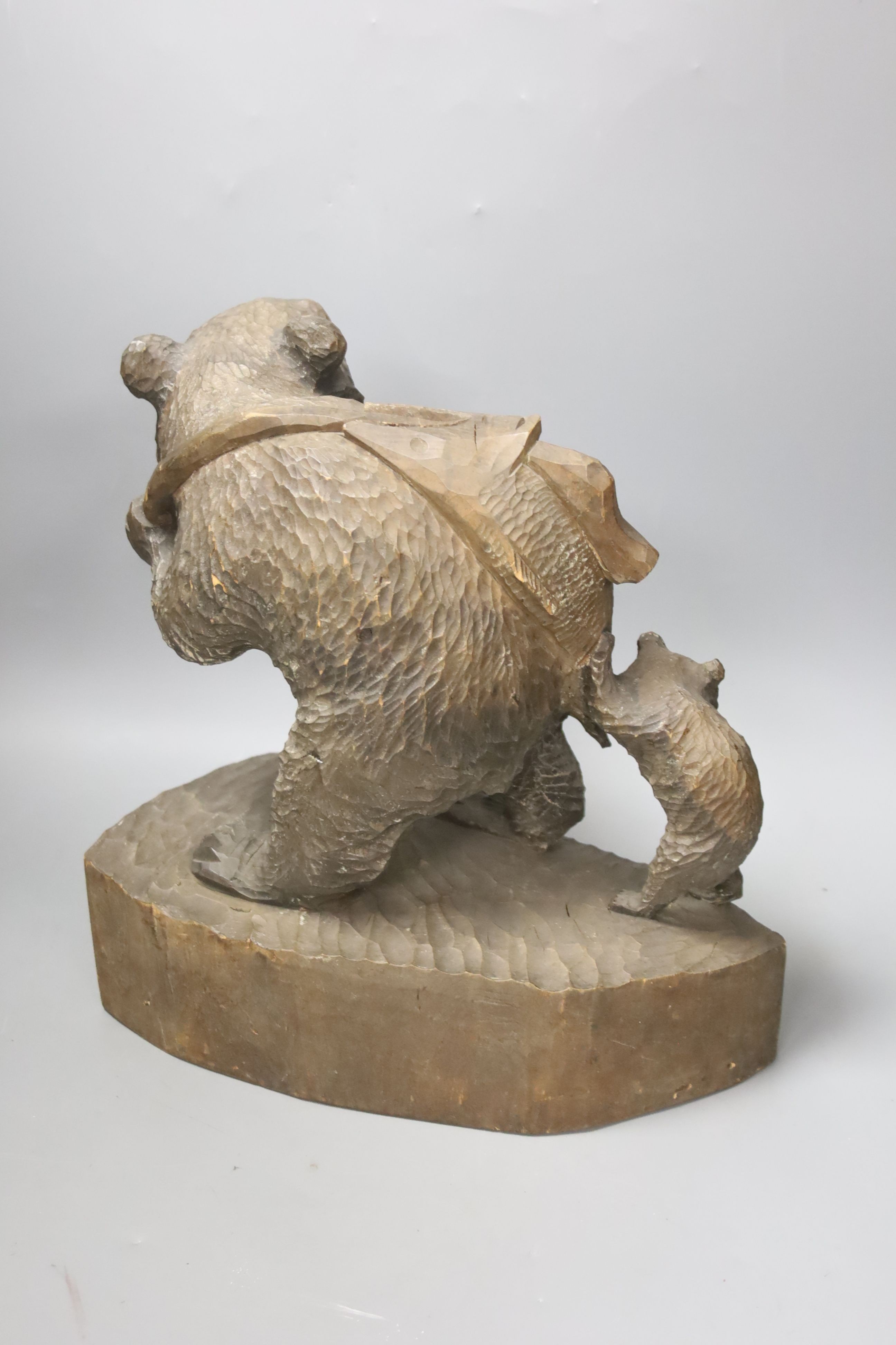 A carved wood fishing bear group 30cm
